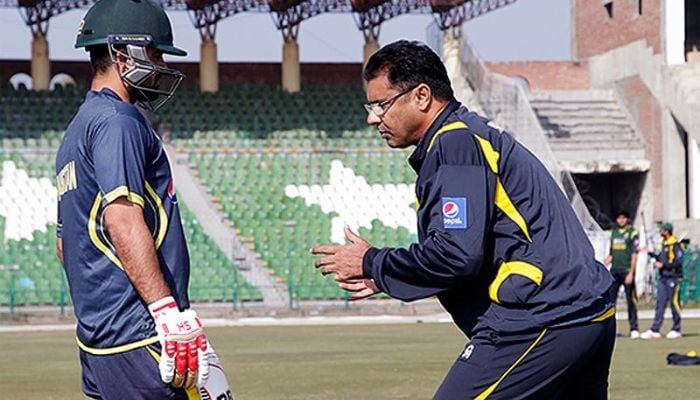 Opening batter Ahmed Shehzad and former bowler and head coach Waqar Younis during a practice session — PCB