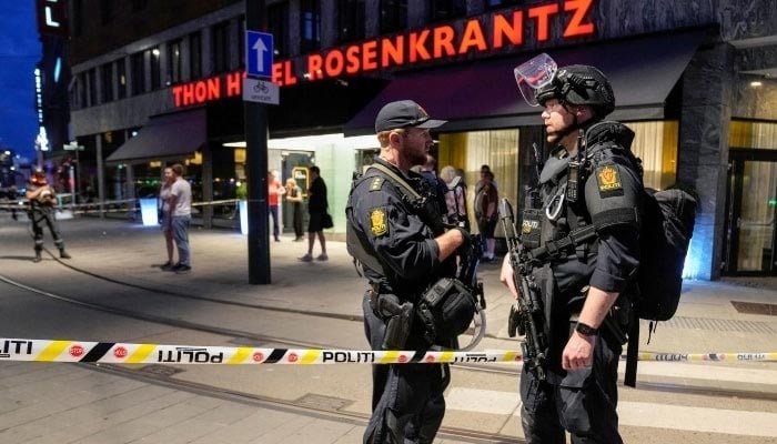 Security forces stand at the site where several people were injured during a shooting outside the London pub in central Oslo, Norway, June 25. — Reuters/File