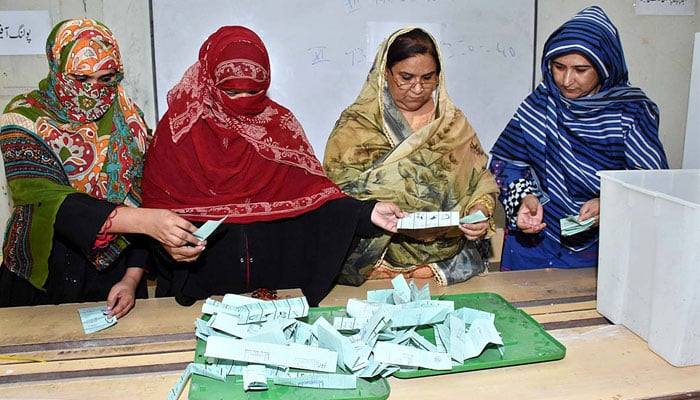 Polling officials counting votes in polling station at Government Girls Degree College during Local Body Elections 2022. — APP