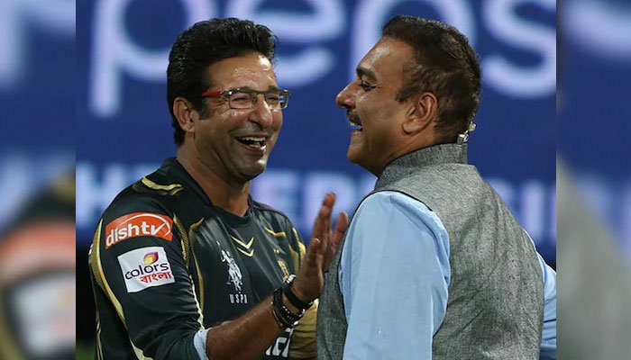 Wasim Akram (L) and Ravi Shastri (R) in cheerful mood during an IPL match. — IPL