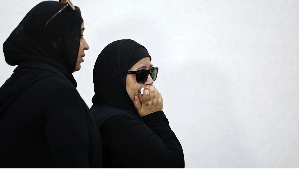 The mother of murdered university of Mansoura student Nayera Ashraf, reacts as she attends the first trial session of the alleged murderer Mohamed Adel, in Mansoura north of Cairo.—AFP