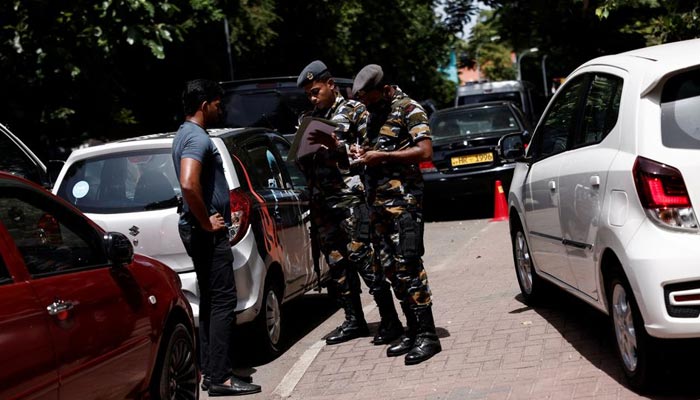 Sri Lankas Air Force members distribute tokens to people queueing for fuel due to fuel shortage, amid the countrys economic crisis, in Colombo, Sri Lanka June 27, 2022. — Reuters