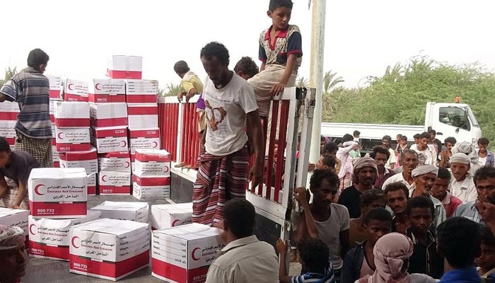Yemenis drop off boxes of humanitarian aid provided by the Emirati Red Crescent in the coastal town of Mujailis, south of the city of Hodeida, on June 6, 2018. — AFP/File
