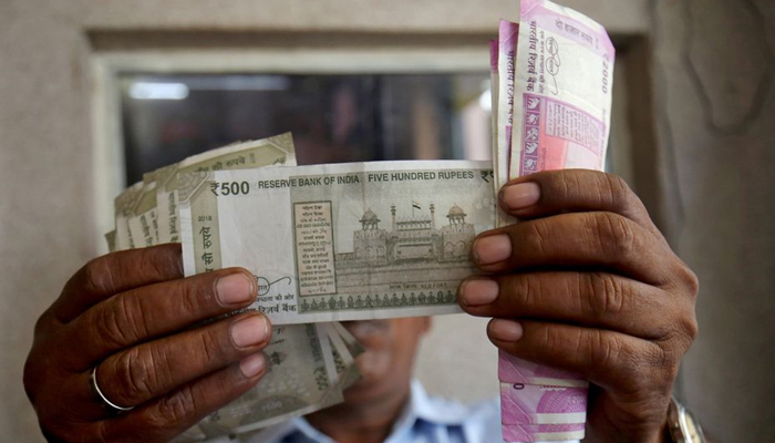 A cashier checks Indian rupee notes inside a room at a fuel station in Ahmedabad, India, on September 20, 2018. — Reuters