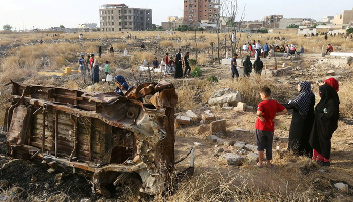 People visit the graves of their loved ones during the first day of the Muslim holiday of Eid-ul-Fitr in Raqqa, Syria, on June 5, 2019. — Reuters