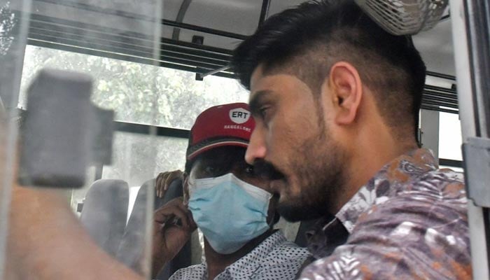 Mohammed Zubair, a journalist and a co-founder of fact-checking website Alt News sits in a police vehicle outside a court in New Delhi, India, June 28, 2022.  — Reuters