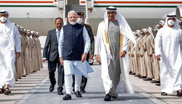 This handout image provided by UAEs Ministry of Presidential Affairs shows UAE President and Ruler of Abu Dhabi Sheikh Mohamed bin Zayed al-Nahyan (CR) receiving Indias Prime Minister Narendra Modi (CL) at the presidential airport in the capital Abu Dhabi on June 28, 2022. — AFP