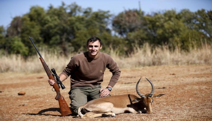 Francois Cloete poses in front of an Impala that he shot at the Iwamanzi Game Reserve in the North West Province on June 6, 2015. Africas big game hunting industry helps protect endangered species, according to its advocates. Opponents say it threatens wildlife. Now a mooted change in regulations in the United States could affect the number of foreigners who come to Africa to hunt big game, damaging the industry and possibly hurting wildlife. —  Reuters/Siphiwe Sibeko