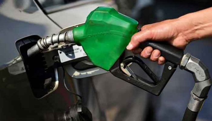 A man refills the fuel tank of a car. — AFP