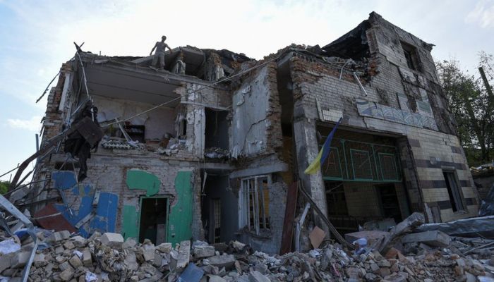 A worker removes debris from a building of a car garage destroyed by a Russian missile strike, as Russias attack on Ukraine continues, in Dnipro, Ukraine June 29, 2022.—Reuters