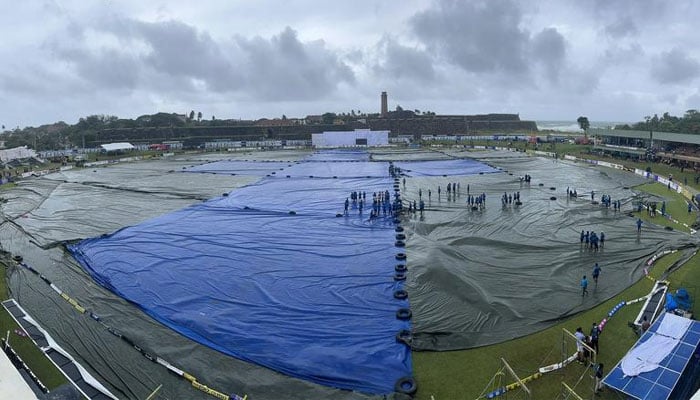 A view of Galle International Stadiums field covered with tarpaulin.