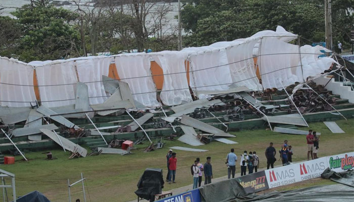 Stand seen heads bowed on the ground after strong gusts of wind blew it away.