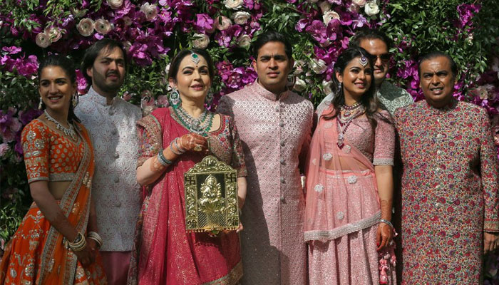 (From left to right) Radhika Merchant, Anant Ambani, Nita Ambani, Akash Ambani, Isha Piramal, Anand Piramal and Mukesh Ambani, the Chairman of Reliance Industries, pose during a photo opportunity at the wedding ceremony of Akash, at Bandra-Kurla Complex in Mumbai, India, March 9, 2019. — Reuters. REUTERS/Francis Mascarenhas