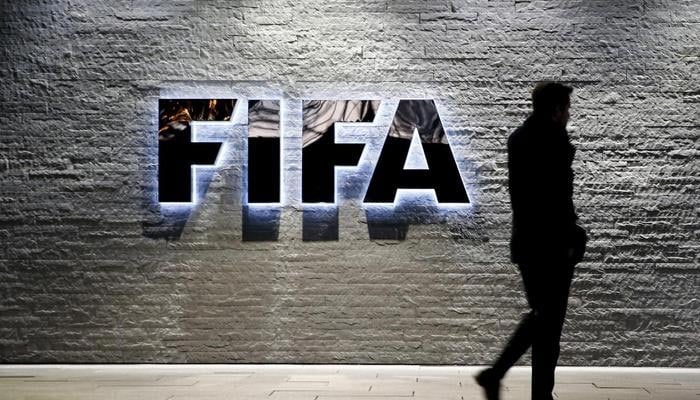 A journalist walks in front of FIFAs headquarters in Zurich, Switzerland December 2, 2015 — Reuters/File