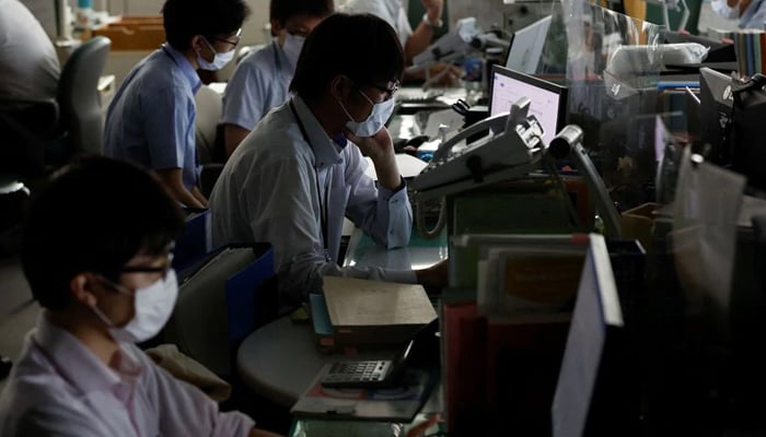 Japanese asked to save power as country's east sizzles 10 Employees of Tokyo Metropolitan Government office work inside the office with partially switched off lights during daytime to take power-saving measures as Japanese government issues warning over possible power crunch due to heatwave in Tokyo, Japan June 30, 2022. — Reuters