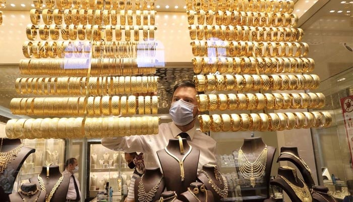 A goldsmith wearing a protective face mask arranges golden bangles as the other talks to customers at a jewellery shop at the Grand Bazaar in Istanbul, Turkey, August 6, 2020. — Reuters/File