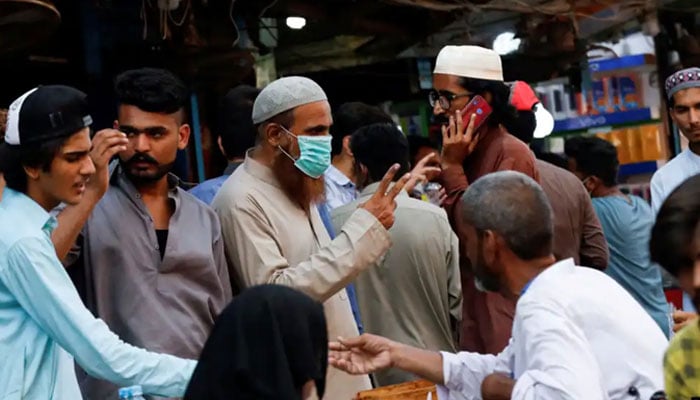 A man wearing a protective face mask gestures while shopping outside an electronics market, after Pakistan started easing lockdown restrictions, as the outbreak of the coronavirus disease continues, in Karachi, Pakistan June 4, 2020. — Reuters/File