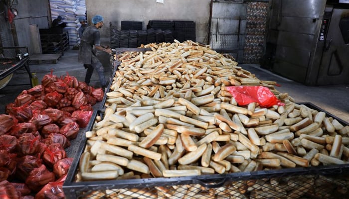 A worker moves bread molds at a bakery in Sanaa, Yemen March 1, 2022. Picture taken March 1, 2022. — Reuters
