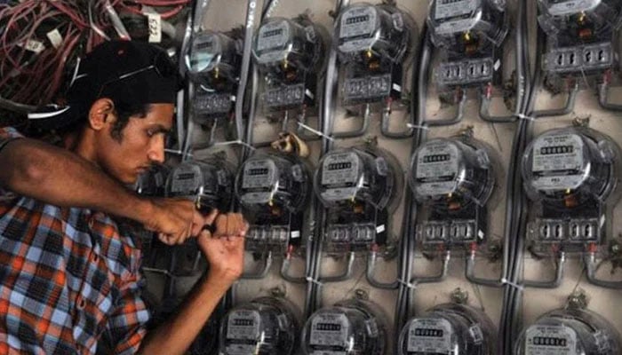 A man installing K-Electric metre . Photo— AFP/File