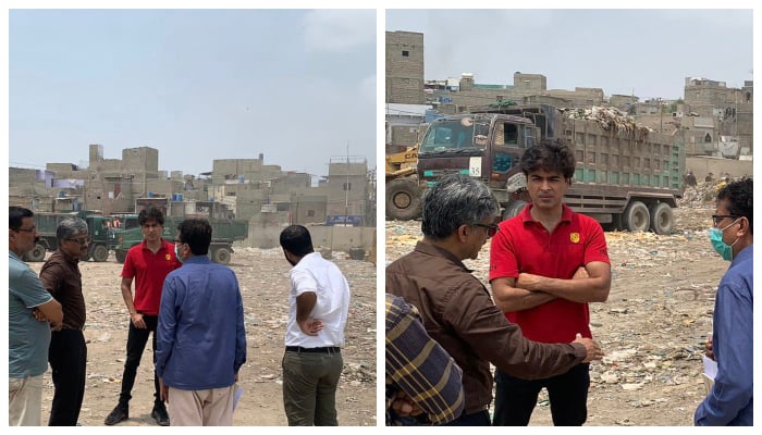 Philanthropist and singer Shahzad Roy (centre) stands at the Dinga Morr dumping site near Karachis Hussainabad, on July 3, 2022. — Twitter/ShehzadRoy