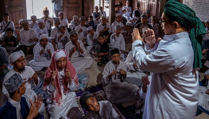 More than 100 deaf children from across Indonesia are learning the Quran by heart at a school on the outskirts of Yogyakarta.—AFP