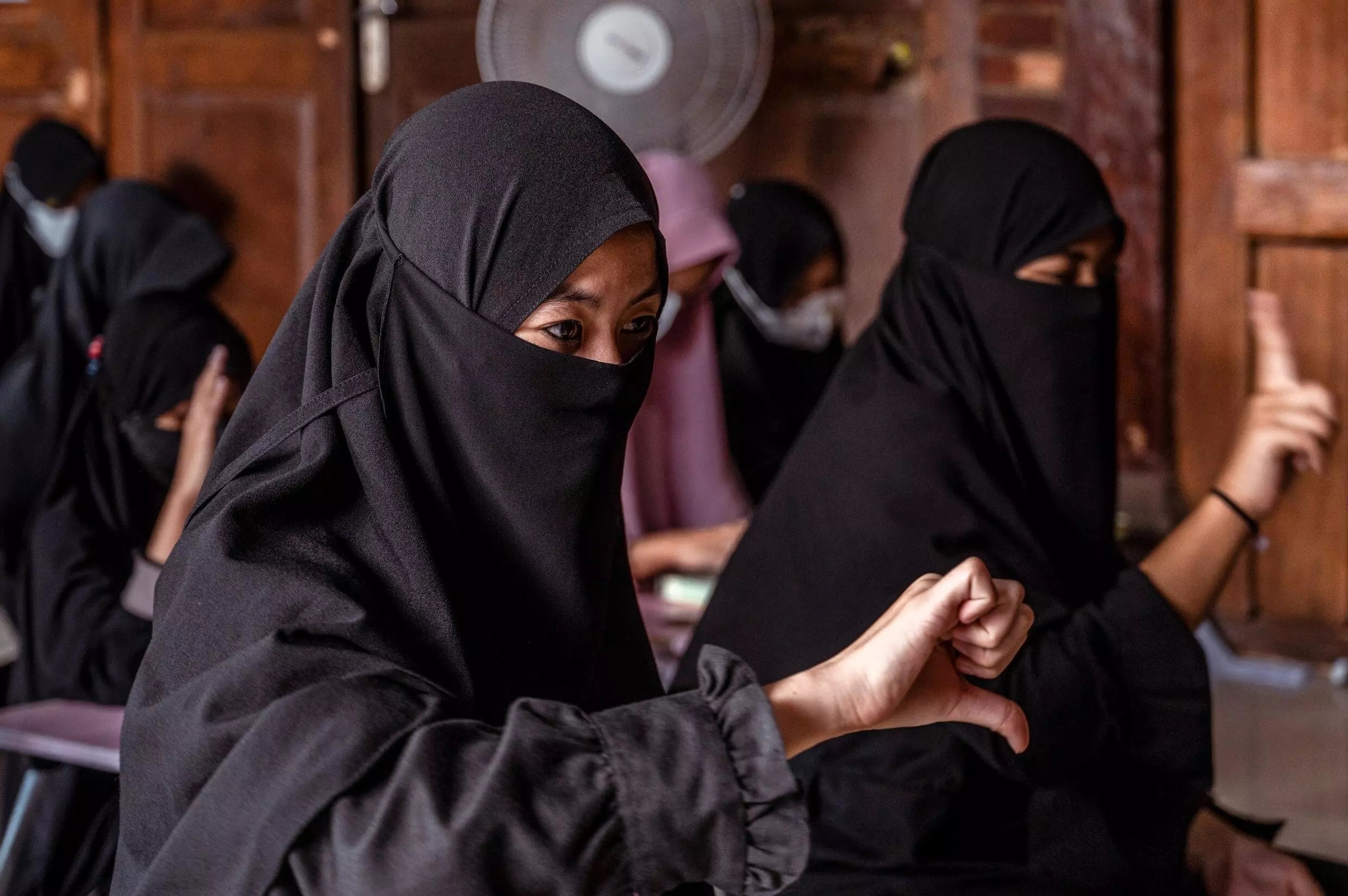 Girls in practice sign language in a class 100 metres from the boys.—AFP