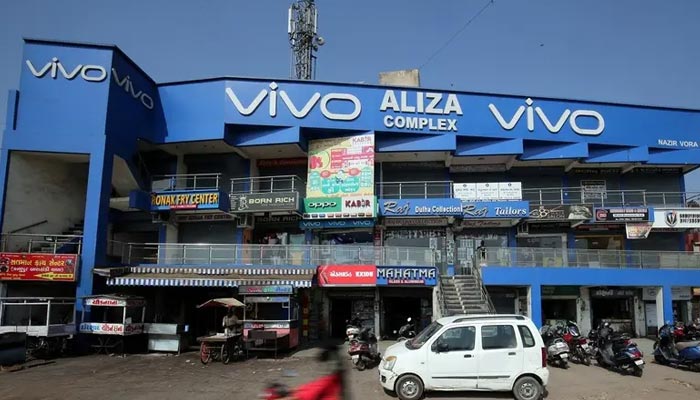 A scooterist rides past a shopping complex with the billboard of Chinese smartphone maker Vivo in Ahmedabad, India, December 14, 2018. — Reuters/File