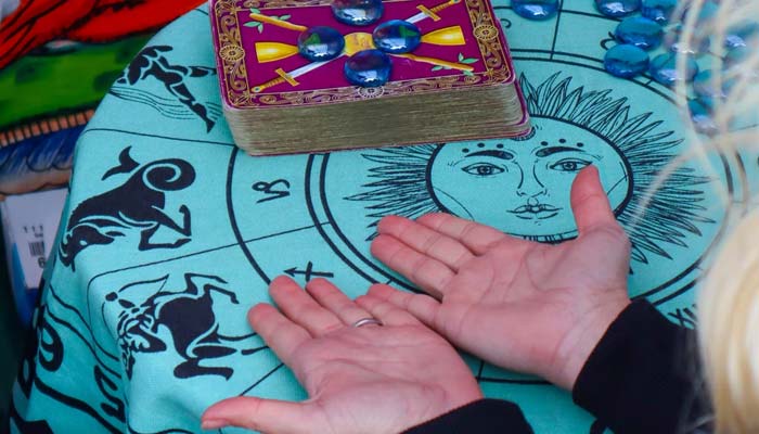 Palm reading with Tarot cards.—Unsplash