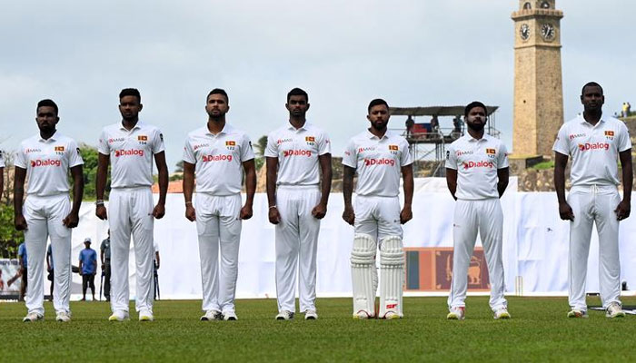 Sri Lankas players stand for the national anthem before the first Test. — AFP