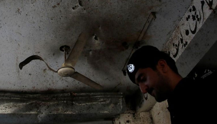 Representational image of a policeman look for evidence under a damaged ceiling after twin bomb attack occurred at a court, in Mardan, Pakistan, September 2, 2016. — Reuters/File