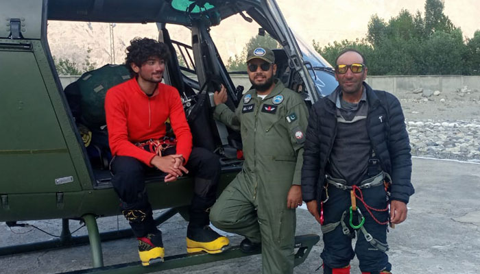 Mountaineers Shehroze Kashif and Fazal Ali with a Pakistan Army pilot. — Alpine Club of Pakistan
