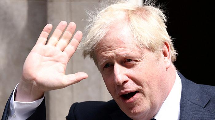 UK's Johnson digs in as over 50 ministers desert government
