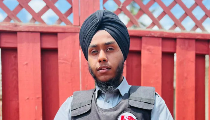 A Sikh guard standing outside a complex. — World Sikh Organisation via CBC