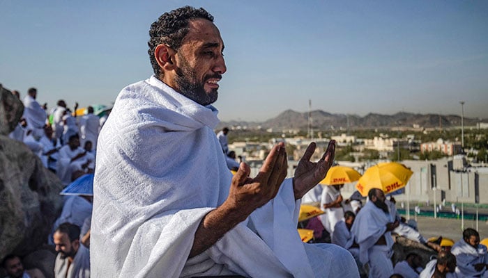 A man cries while praying atop Mount Arafat in Mecca. — AFP