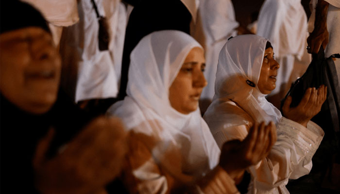 Pilgrims pray on Mount of Mercy at the plain of Arafat during the annual Haj. — Reuters