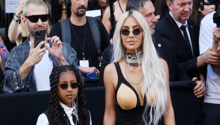 Kim Kardashian’s daughter North West holds ‘stop’ sign for paparazzi at Paris fashion show