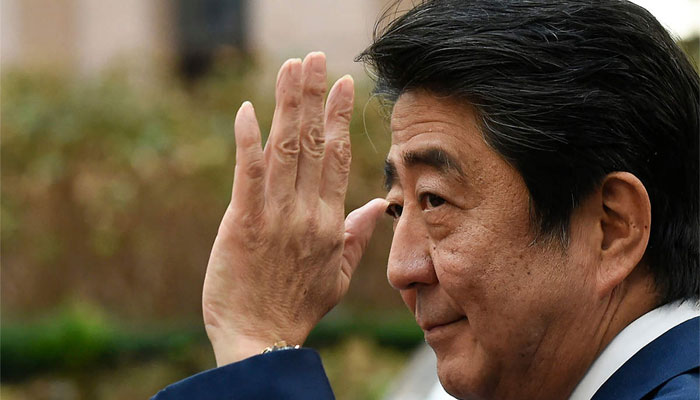 Former Japanese premier Shinzo Abe waves at people. — AFP/File