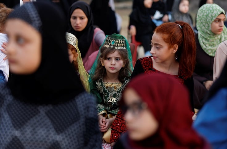 A Palestinian girl looks on as she attends Eid al-Adha prayers, on the first day of Muslim holiday of Eid al-Adha, in Khan Younis, in the southern Gaza Strip July 9, 2022.