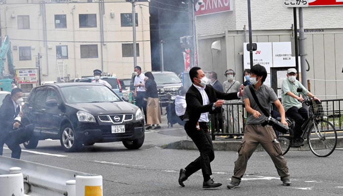 A police officer detains a man, believed to have shot former Japanese Prime Minister Shinzo Abe, in Nara, western Japan July 8, 2022 — The Asahi Shimbun/via Reuters/File