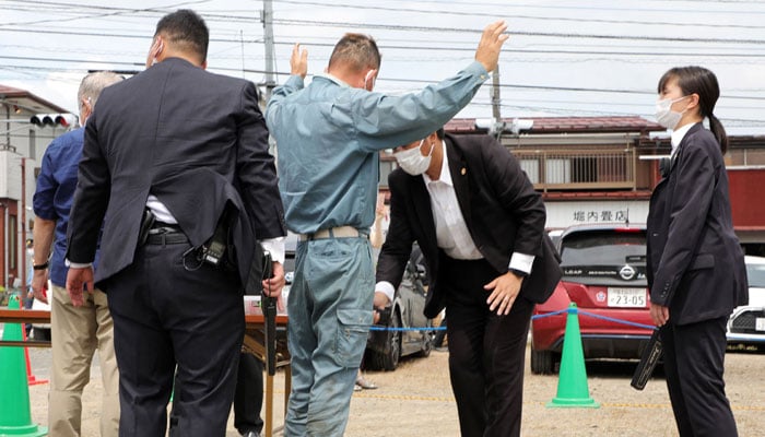 Visitors at the street speech venue for an election campaign, go through security in Fujiyoshida City, Yamanashi prefecture on July 9, 2022 ahead of the polling day of the Upper House election on July 10. — AFP