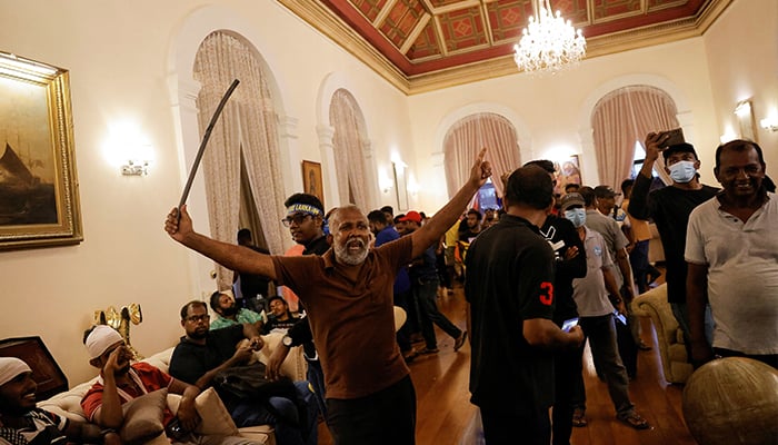 A demonstrator celebrates after entering the Presidents House during a protest, after President Gotabaya Rajapaksa fled, amid the countrys economic crisis, in Colombo, Sri Lanka July 9, 2022. — Reuters