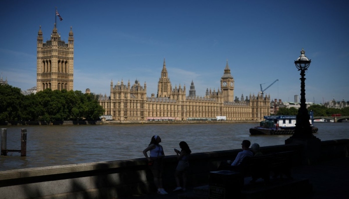 People walk near to the Houses of Parliament in London, Britain, July 11, 2022. Photo— REUTERS/Henry Nicholls