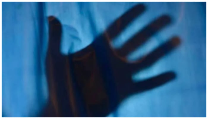 Representational image showing the shadow of a persons hand against a blue background. — Geo.tv illustration/ File