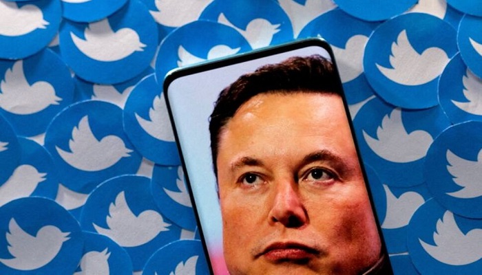 An image of Elon Musk is seen on smartphone placed on printed Twitter logos in this picture illustration taken April 28, 2022. Photo: Reuters