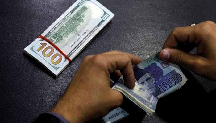 A local currency dealer counts Pakistani rupees in Karachi in this undated photo. — Reuters