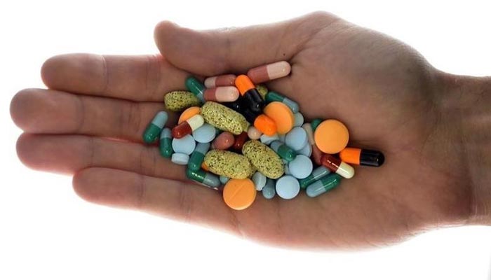 A person holds pharmaceutical tablets and capsules in this picture illustration taken in Ljubljana.— Reuters/File
