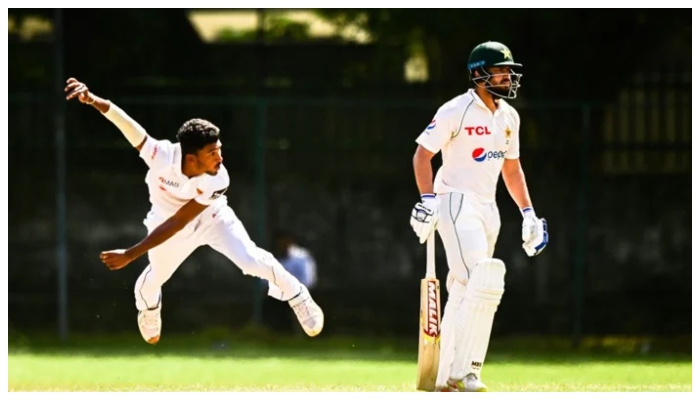 A Sri Lankan bowler bowls while Pakistani opener Mohammad Rizwan waits to take a run. — AFP