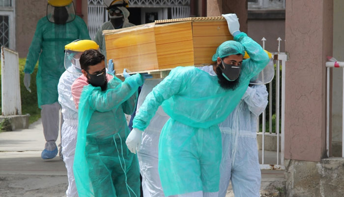 Healthcare workers are carrying dead body during peak COVID-19 times. Photo — Reuters