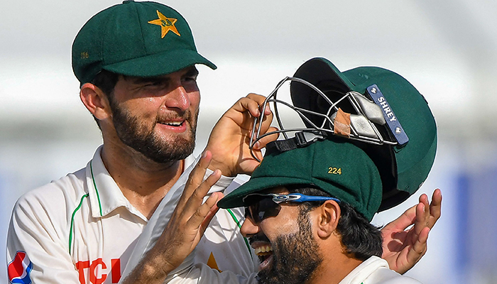 Pakistans Shaheen Afridi (L) and Mohammad Rizwan walk back to the pavilion at the end of Sri Lanka first innings during the first day of play of the first cricket Test match between Sri Lanka and Pakistan at the Galle International Cricket Stadium in Galle on July 16, 2022. — AFP