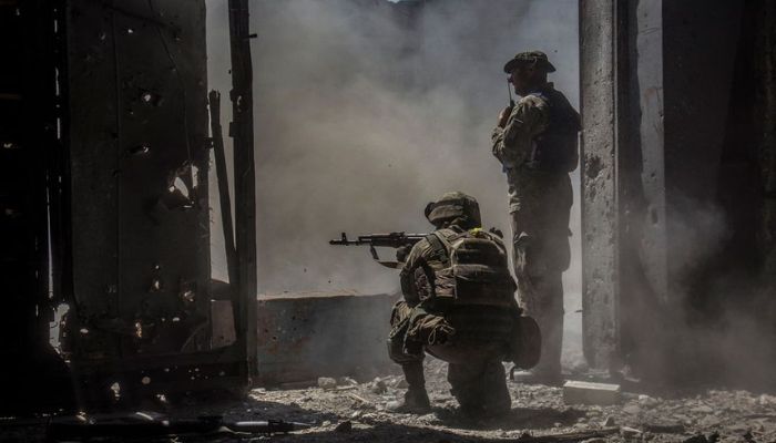 Ukrainian service members watch while a tank (not pictured) fires toward Russian troops in the industrial area of the city of Sievierodonetsk, as Russias attack on Ukraine continues, Ukraine June 20, 2022. — Reuters